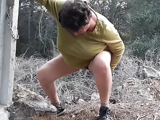 My old bitch relieves herself in nature